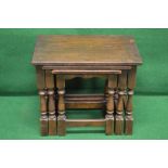 A nest of three oak occasional tables having moulded tops on turned legs ending in block feet