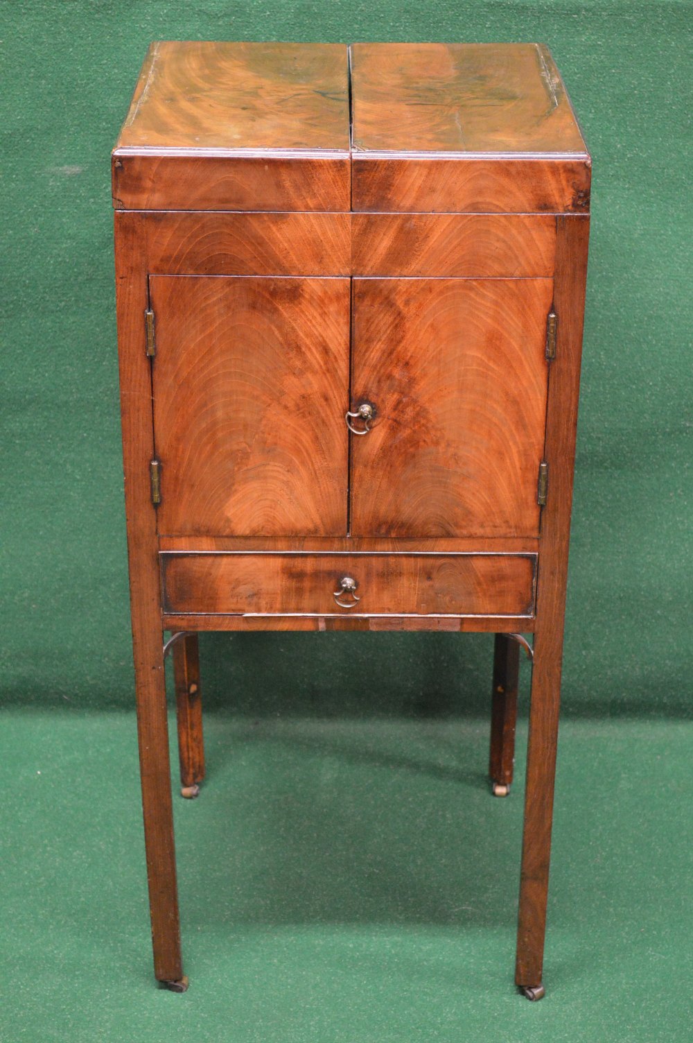 A Georgian mahogany night/washstand the top opening to reveal basin and beaker spaces over two