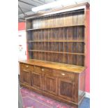 Victorian pine dresser having moulded cornice over three shelf inverted waterfall plate rack above