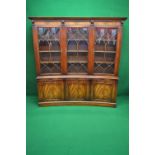 20th century mahogany inverted bow front bookcase having three glazed doors enclosing nine shelves