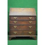 Georgian oak bureau having fall front enclosing fitted interior of drawers and pigeon holes over