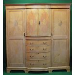 Inlaid mahogany bow fronted triple wardrobe having two centre doors over secret drawer,