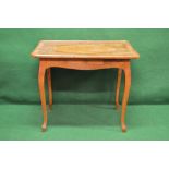 A walnut and burr walnut centre table the top being crossbanded and inlaid with flower heads around