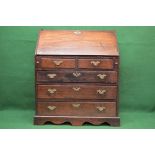 Georgian oak bureau having fall front opening to reveal fitted interior over two short and three