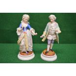 Pair of Augustus Rex figures of lady and gentleman each holding a single flower,