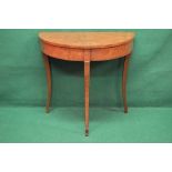 A 20th century walnut cross banded demi lune side table standing on three square sabre legs - 33"