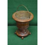 Circular oak cellarette having brass swing handle and liner,