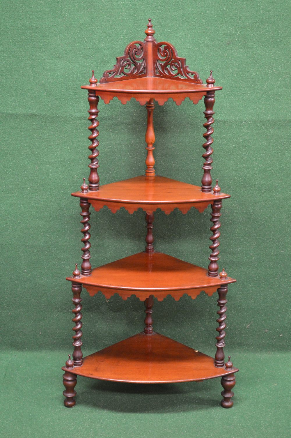 Mahogany graduated four tier corner what-not having raised fretwork top,