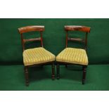 Set of four Georgian mahogany dining chairs with curved backs over padded seats and turned legs