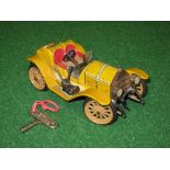 Schuco, a tinplate clockwork model of a 1913 Type 355 Mercer open car in yellow livery - 7" long,