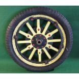 A wooden spoked road vehicle wheel with a key fit hub,
