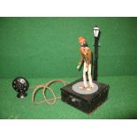 Dancing figure toy comprising of metal battery box with speaker topped by an articulated wooden man