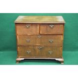 Walnut chest of four drawers with moulded top over two short and two long drawers with brass