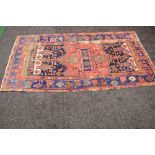 Red ground rug with blue,