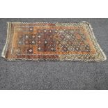 Brown ground rug with orange and blue pattern - 56" x 35"