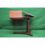 An adjustable Victorian mahogany reading table having part leather top and two adjustable book