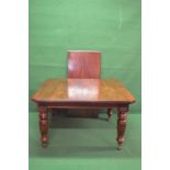 Mahogany wind out dining table having cut corners with moulded edge and supported on turned and