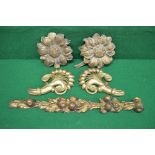 Pair of gilt wood carved flower heads together with a pair of gilt wood carved wall decorations in