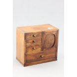 A Small Oak Table Top Cabinet with four drawers and slide door revealing two further drawers