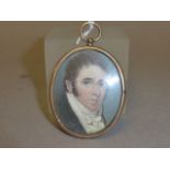 A Georgian Miniature Oval Portrait of a Gentleman painted on mother of pearl with an oval yellow
