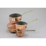 A Set of Five Graduating Copper Saucepans with brass handles