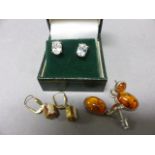 A Pair of Silver and Amber Earrings, a Pair of Cameo Earrings and a Pair of CZ Earrings