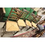 A Set of Four Oak Ladder Back Dining Chairs with string seats