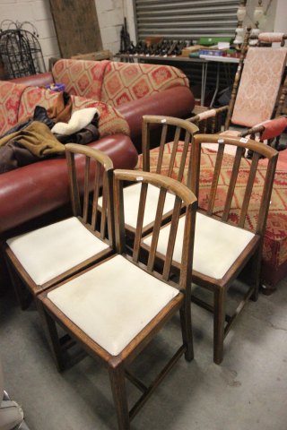 A Set of Four Oak Square Stick Back Dining Chairs