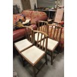 A Set of Four Oak Square Stick Back Dining Chairs