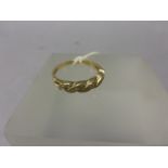 9ct Yellow Gold Twist Ring set with 15 small diamonds