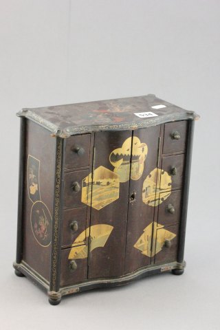 A Small Japanese Table Cabinet with fir cone handles to drawers behind a pair of doors