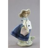 A Lladro Figure of Girl in Blue Dress Carrying Flower Basket