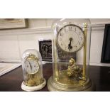 A Schatz Glass Domed Cased Anniversary Clock and one other