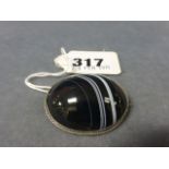 A Black Oval Polished Agate Brooch on white metal mount