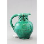 A Baron of Barnstaple Mottoware Green Glazed Puzzle Jug