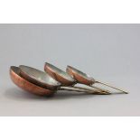 Four Graduating Copper and Brass Frying Pans