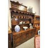 Antique Style Oak Dresser with panelled back shelves over four drawers and four cupboards