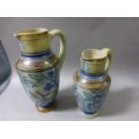 Two 19th century Graduating Martin Brothers Stoneware Jugs decorated with birds in trees (thought to