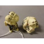 Two Netsuke including Man carrying head in sack and a Happy Buddha