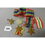 Four World War II Medals including 1939-45 Star, Italy Star and Africa Star with ribbons