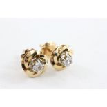 Pair of 18ct Earrings in the form of flowers set with clear stones