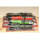 Four model train locomotives on stands including LNER Flying Scotsman, Pacific Chapeleon Nord,