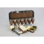 Black Forest Wooden Pipe Rack with Seven Carved Character Faces together with Cased Meerschaum