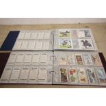 Two folders of cigarette cards including Wills, Players, Carreras etc