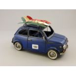 Tin plate model of a vintage Fiat car with surf boards to roof