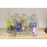 Nine vintage Advertising Milk Bottles