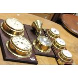 Two Sets of Clock & Barometers on Wooden Plinth together with a Clock and Bell on Plinth