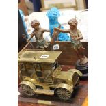 Pair of Spelter Figures of Cherubs together with a Gilt Metal Vintage Style Taxi on Wooden Stand