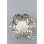 Small Silver Scalloped Shaped Bowl with pierced edge raised on three pad feet, hallmarks rubbed