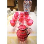 19th century Cranberry Glass Jug together with Twelve Cranberry Wine Glasses